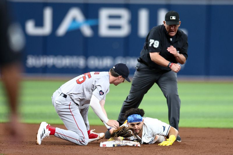 Sep 19, 2024; St. Petersburg, Florida, USA; Tampa Bay Rays first baseman Jonathan Aranda (62) is tagged out by Boston Red Sox second baseman Nick Sogard (75) in the sixth inning at Tropicana Field. Mandatory Credit: Nathan Ray Seebeck-Imagn Images