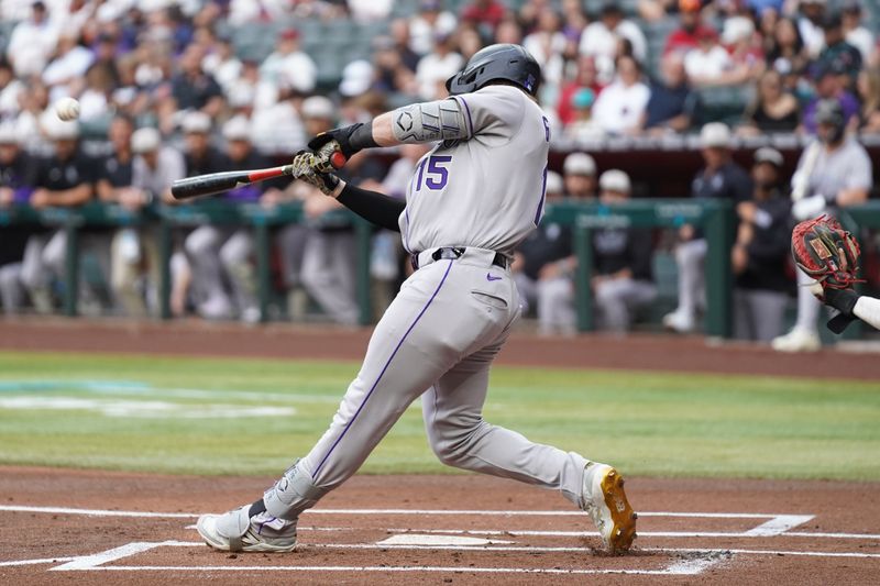 May 17, 2025; Phoenix, Arizona, USA;  Colorado Rockies catcher Hunter Goodman (15) hits a home run in the first inning against the Arizona Diamondbacks at Chase Field. Mandatory Credit: Jacob Reiner-Imagn Images