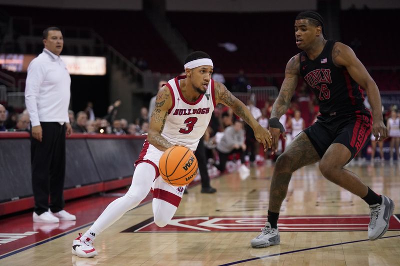 Feb 14, 2024; Fresno, California, USA; Fresno State Bulldogs guard Isaiah Hill (3) dribbles past UNLV Rebels guard Luis Rodriguez (15) in the second half at the Save Mart Center. Mandatory Credit: Cary Edmondson-USA TODAY Sports