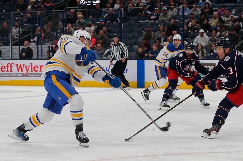 Oct 17, 2024; Columbus, Ohio, USA; Buffalo Sabres center Jiri Kulich (20) wrists a shot on goal as Columbus Blue Jackets defenseman Jack Johnson (3) defends during the third period at Nationwide Arena. Mandatory Credit: Russell LaBounty-Imagn Images