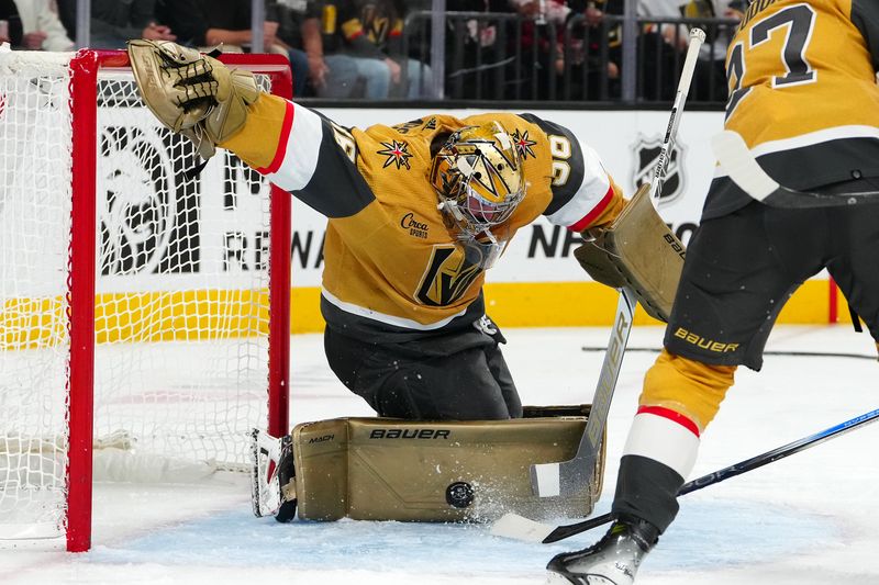 Nov 2, 2023; Las Vegas, Nevada, USA; Vegas Golden Knights goaltender Logan Thompson (36) makes a save against the Winnipeg Jets during the second period at T-Mobile Arena. Mandatory Credit: Stephen R. Sylvanie-USA TODAY Sports