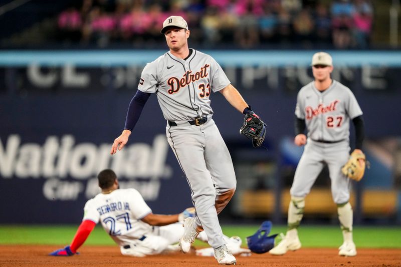 May 17, 2025; Toronto, Ontario, CAN;  Detroit Tigers second base Colt Keith (33) throws to first base against the Toronto Blue Jays during the seventh inning at Rogers Centre. Mandatory Credit: Kevin Sousa-Imagn Images