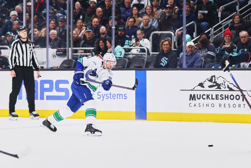 Feb 28, 2026; Seattle, Washington, USA; Vancouver Canucks defenseman Marcus Pettersson (29) takes a shot on goal during the first period against the Seattle Kraken at Climate Pledge Arena. Mandatory Credit: Blake Dahlin-Imagn Images