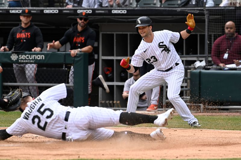 Apr 5, 2023; Chicago, Illinois, USA;  Chicago White Sox left fielder Andrew Benintendi (23) reacts after scoring as Chicago White Sox first baseman Andrew Vaughn (25) is tagged out by San Francisco Giants catcher Roberto Perez (1) during the first inning at Guaranteed Rate Field. Mandatory Credit: Matt Marton-USA TODAY Sports