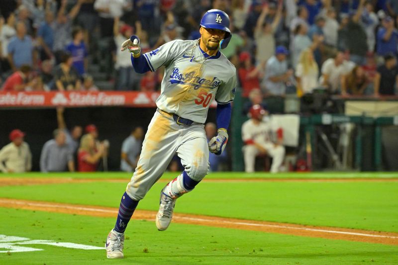 Sep 3, 2024; Anaheim, California, USA;  Los Angeles Dodgers shortstop Mookie Betts (50) celebrates as he rounds the bases after hitting a three-run home run in the tenth inning against the Los Angeles Angels at Angel Stadium. Mandatory Credit: Jayne Kamin-Oncea-Imagn Images