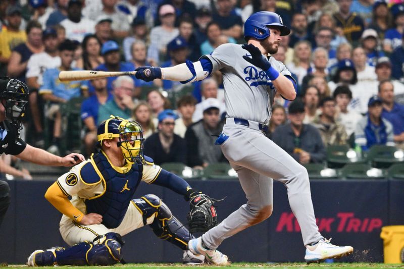 Aug 15, 2024; Milwaukee, Wisconsin, USA; Los Angeles Dodgers second baseman Gavin Lux (9) hits a single to drive in a run in the third inning against the Milwaukee Brewers at American Family Field. Mandatory Credit: Benny Sieu-USA TODAY Sports