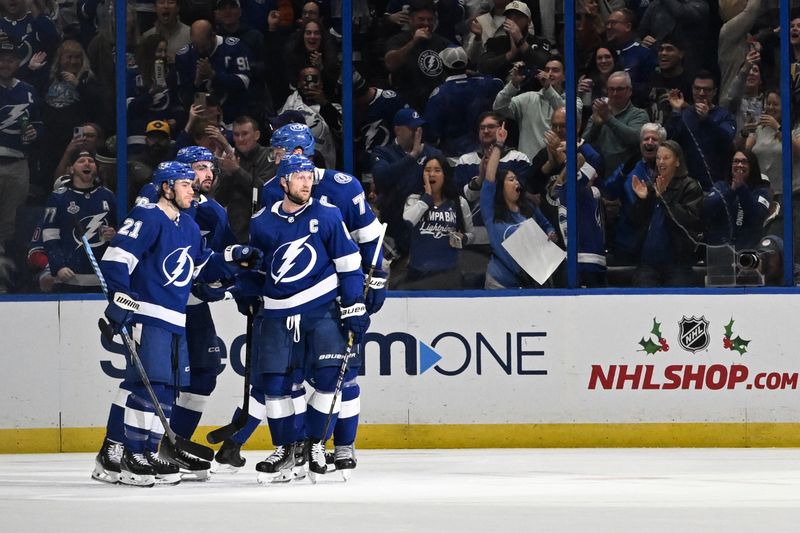 Dec 21, 2023; Tampa, Florida, USA; Members of the Tampa Bay Lightning celebrate a goal in the second period against the Las Vegas Golden Knights at Amalie Arena. Mandatory Credit: Jonathan Dyer-USA TODAY Sports