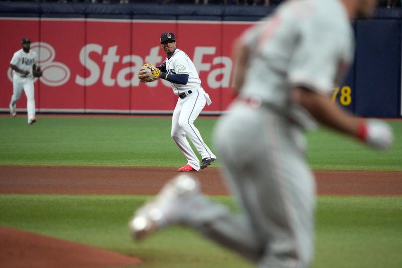 Jul 4, 2023; St. Petersburg, Florida, USA; Tampa Bay Rays shortstop Wander Franco (5) fields a ball hit by Philadelphia Phillies catcher J.T. Realmuto during the fourth inning at Tropicana Field. Mandatory Credit: Dave Nelson-USA TODAY Sports