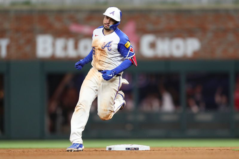 Apr 20, 2024; Cumberland, Georgia, USA;  Atlanta Braves catcher Travis d'Arnaud (16) rounds second base against the Texas Ranger in the eighth inning at Truist Park. Mandatory Credit: Mady Mertens-USA TODAY Sports