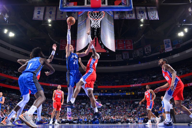 PHILADELPHIA, PA - APRIL 12: Moritz Wagner #21 of the Orlando Magic drives to the basket during the game against the Philadelphia 76ers on April 12, 2024 at the Wells Fargo Center in Philadelphia, Pennsylvania NOTE TO USER: User expressly acknowledges and agrees that, by downloading and/or using this Photograph, user is consenting to the terms and conditions of the Getty Images License Agreement. Mandatory Copyright Notice: Copyright 2024 NBAE (Photo by Jesse D. Garrabrant/NBAE via Getty Images)