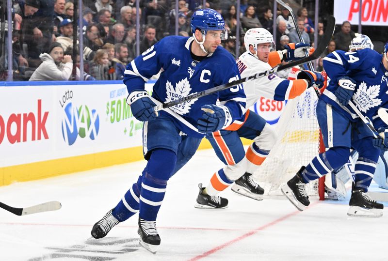 Feb 5, 2024; Toronto, Ontario, CAN;   Toronto Maple Leafs forward John Tavares (91) pursues the play ahead of New York Islanders forward Brock Nelson (29) in the second period at Scotiabank Arena. Mandatory Credit: Dan Hamilton-USA TODAY Sports