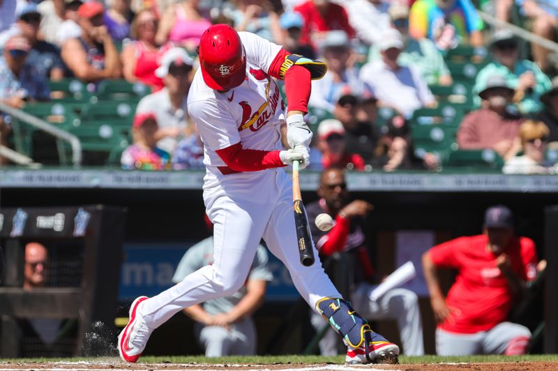 Mar 11, 2024; Jupiter, Florida, USA; St. Louis Cardinals designated hitter Nolan Arenado (28) hits a single against the Washington Nationals during the first inning at Roger Dean Chevrolet Stadium. Mandatory Credit: Sam Navarro-USA TODAY Sports