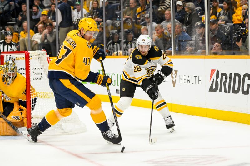 Oct 22, 2024; Nashville, Tennessee, USA; Nashville Predators right wing Michael McCarron (47) takes the puck from Boston Bruins center Elias Lindholm (28) during the second period at Bridgestone Arena. Mandatory Credit: Steve Roberts-Imagn Images