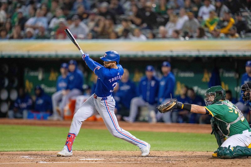 Sep 24, 2024; Oakland, California, USA; Texas Rangers center fielder Leody Taveras (3) singles against the Oakland Athletics during the fourth inning at Oakland-Alameda County Coliseum. Mandatory Credit: Neville E. Guard-Imagn Images