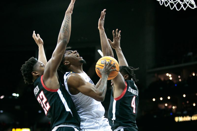 Mar 8, 2023; Kansas City, MO, USA; West Virginia Mountaineers guard Kedrian Johnson (0) collides with Texas Tech Red Raiders guard Elijah Fisher (22) and Texas Tech Red Raiders forward Robert Jennings (4) under the basket during the first half at T-Mobile Center. Mandatory Credit: William Purnell-USA TODAY Sports