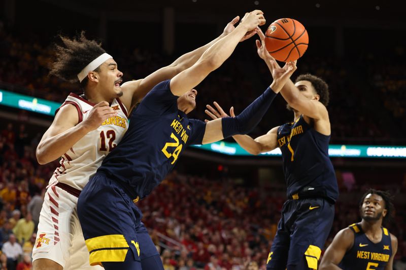 Feb 27, 2023; Ames, Iowa, USA; West Virginia Mountaineers forward Patrick Suemnick (24), West Virginia Mountaineers forward Emmitt Matthews Jr. (1) and Iowa State Cyclones forward Robert Jones (12) battle for a lose ball during the second half at James H. Hilton Coliseum. Mandatory Credit: Reese Strickland-USA TODAY Sports