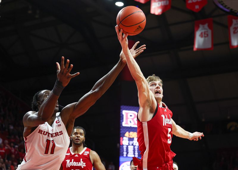 Feb 14, 2023; Piscataway, New Jersey, USA; Nebraska Cornhuskers guard Sam Griesel (5) rebounds against Rutgers Scarlet Knights center Clifford Omoruyi (11) during the second half at Jersey Mike's Arena. Mandatory Credit: Vincent Carchietta-USA TODAY Sports