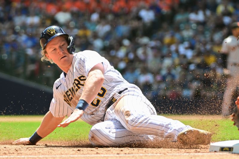 May 28, 2023; Milwaukee, Wisconsin, USA;  Milwaukee Brewers center fielder Joey Wiemer (28) steals third base against the San Francisco Giants in the second inning at American Family Field. Mandatory Credit: Benny Sieu-USA TODAY Sports