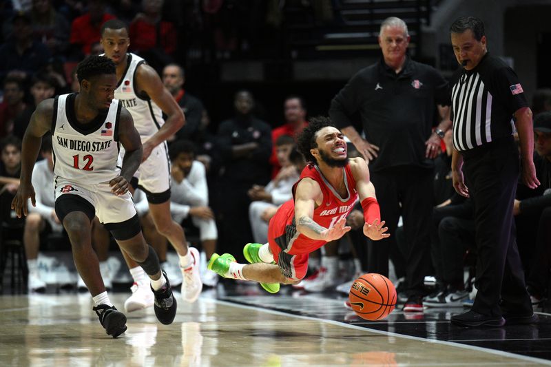 Jan 14, 2023; San Diego, California, USA; New Mexico Lobos guard Jaelen House (10) falls attempting to recover a loose ball as San Diego State Aztecs guard Darrion Trammell (12) looks on during the second half at Viejas Arena. Mandatory Credit: Orlando Ramirez-USA TODAY Sports