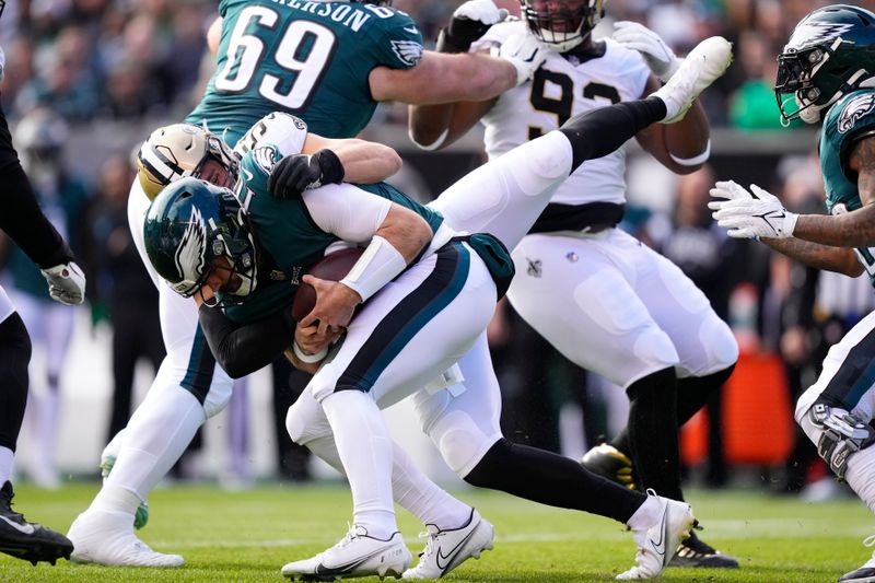 Philadelphia Eagles quarterback Gardner Minshew is sacked by New Orleans Saints linebacker Kaden Elliss in the first half of an NFL football game in Philadelphia, Sunday, Jan. 1, 2023. (AP Photo/Matt Rourke)