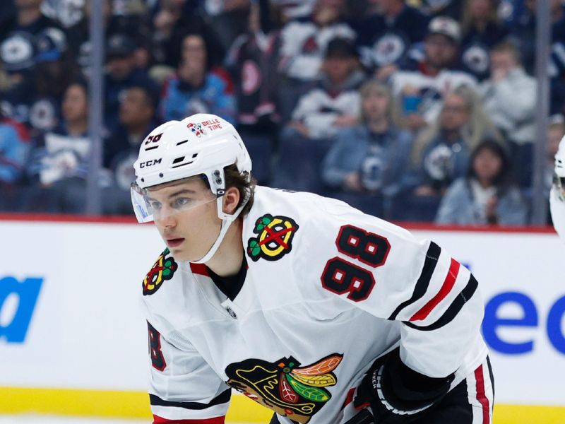 Oct 11, 2024; Winnipeg, Manitoba, CAN; Chicago Blackhawks forward Connor Bedard (98) awaits the face-off against the Winnipeg Jets during the second period at Canada Life Centre. Mandatory Credit: Terrence Lee-Imagn Images