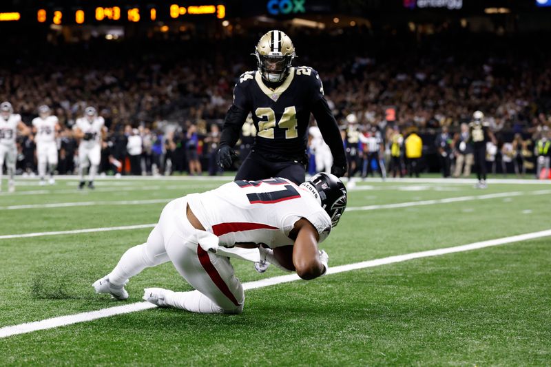 Atlanta Falcons tight end Jonnu Smith (81) scores a touchdown against New Orleans Saints safety Johnathan Abram (24) in the first half of an NFL football game in New Orleans, Sunday, Jan. 7, 2024. (AP Photo/Butch Dill)