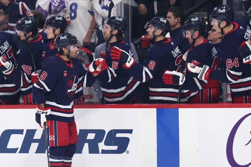 Nov 9, 2024; Winnipeg, Manitoba, CAN; Winnipeg Jets left wing Alex Iafallo (9) celebrates his first period goal against the Dallas Stars at Canada Life Centre. Mandatory Credit: James Carey Lauder-Imagn Images