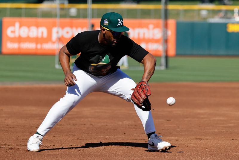 May 20, 2025; West Sacramento, California, USA; Athletics third base Miguel Andujar (22) fields grounders before the game against the Los Angeles Angels at Sutter Health Park. Mandatory Credit: Sergio Estrada-Imagn Images