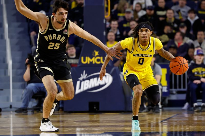 Feb 25, 2024; Ann Arbor, Michigan, USA;  Michigan Wolverines guard Dug McDaniel (0) dribbles against Purdue Boilermakers guard Ethan Morton (25) in the first half at Crisler Center. Mandatory Credit: Rick Osentoski-USA TODAY Sports