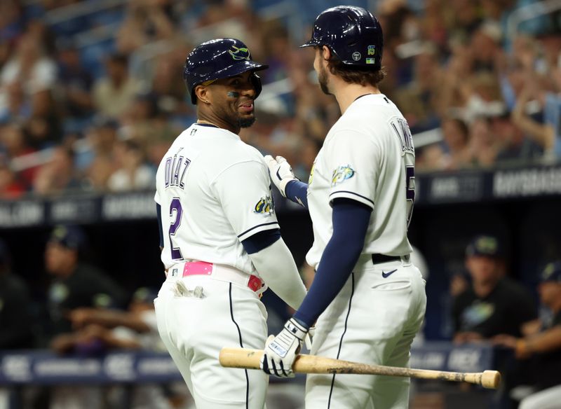 Sep 8, 2023; St. Petersburg, Florida, USA; Tampa Bay Rays first baseman Yandy Diaz (2) is congratulated by  right fielder Josh Lowe (15) after he scored a run against the Seattle Mariners during the first inning at Tropicana Field. Mandatory Credit: Kim Klement Neitzel-USA TODAY Sports