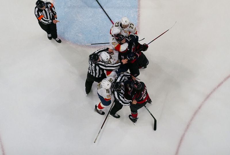 Mar 14, 2024; Raleigh, North Carolina, USA; Florida Panthers and Carolina Hurricanes players battle during the third period at PNC Arena. Mandatory Credit: James Guillory-USA TODAY Sports