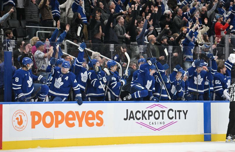 Nov 16, 2024; Toronto, Ontario, CAN;   Toronto Maple Leafs players and fans celebrate after an overtime winning goal by forward Mitch Marner (not shown) against the Edmonton Oilers at Scotiabank Arena. Mandatory Credit: Dan Hamilton-Imagn Images