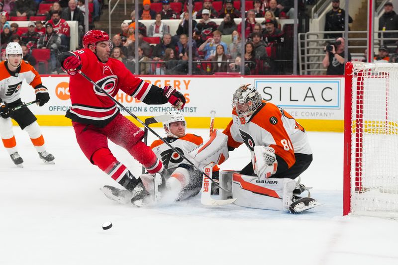 Dec 14, 2025; Raleigh, North Carolina, USA;  Philadelphia Flyers defenseman Emil Andrae (36) collides with Philadelphia Flyers defenseman Emil Andrae (36) and goaltender Dan Vladar (80) during the first period at Lenovo Center. Mandatory Credit: James Guillory-Imagn Images