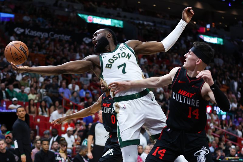 MIAMI, FLORIDA - FEBRUARY 11: Jaylen Brown #7 of the Boston Celtics rebounds the ball against Tyler Herro #14 of the Miami Heat during the first quarter of the game at Kaseya Center on February 11, 2024 in Miami, Florida. NOTE TO USER: User expressly acknowledges and agrees that, by downloading and or using this photograph, User is consenting to the terms and conditions of the Getty Images License Agreement. (Photo by Megan Briggs/Getty Images)