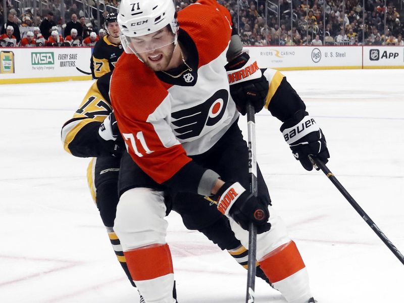 Feb 25, 2024; Pittsburgh, Pennsylvania, USA;  Philadelphia Flyers right wing Tyson Foerster (71) handles the puck ahead of Pittsburgh Penguins right wing Bryan Rust (17) during the second period at PPG Paints Arena. Mandatory Credit: Charles LeClaire-USA TODAY Sports