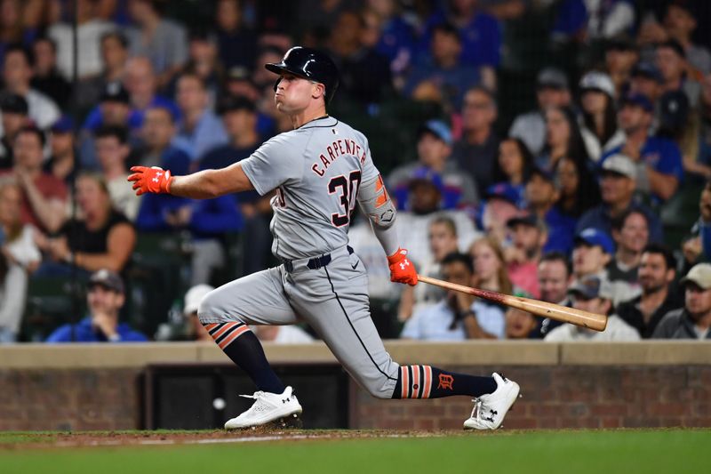 Aug 21, 2024; Chicago, Illinois, USA; Detroit Tigers right fielder Kerry Carpenter (30) hits a three-run home run during the ninth inning against the Chicago Cubs at Wrigley Field. Mandatory Credit: Patrick Gorski-USA TODAY Sports