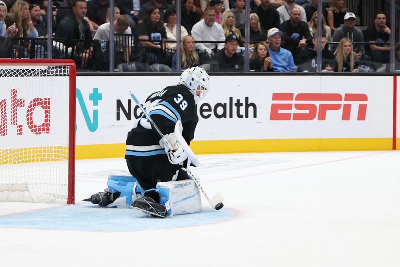 Oct 8, 2024; Salt Lake City, Utah, USA; Utah Hockey Club goaltender Connor Ingram (39) blocks a shot against the Chicago Blackhawks during the third period at Delta Center. Mandatory Credit: Rob Gray-Imagn Images