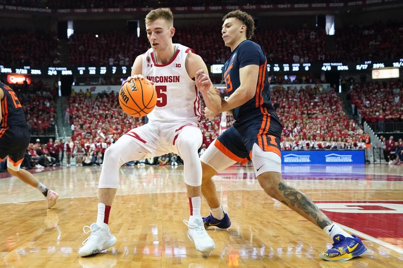 Jan 28, 2023; Madison, Wisconsin, USA;  Wisconsin Badgers forward Tyler Wahl (5) dribbles the ball under coverage by Illinois Fighting Illini forward Coleman Hawkins (33) during the second half at the Kohl Center. Mandatory Credit: Kayla Wolf-USA TODAY Sports