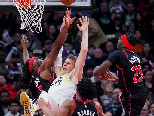 TORONTO, ON - DECEMBER 23: Lauri Markkanen #23 of the Utah Jazz goes to the basket against Chris Boucher #25, Scottie Barnes #4, and Precious Achiuwa #5 of the Toronto Raptors during the first half of their basketball game at the Scotiabank Arena on December 23, 2023 in Toronto, Ontario, Canada. NOTE TO USER: User expressly acknowledges and agrees that, by downloading and/or using this Photograph, user is consenting to the terms and conditions of the Getty Images License Agreement. (Photo by Mark Blinch/Getty Images)