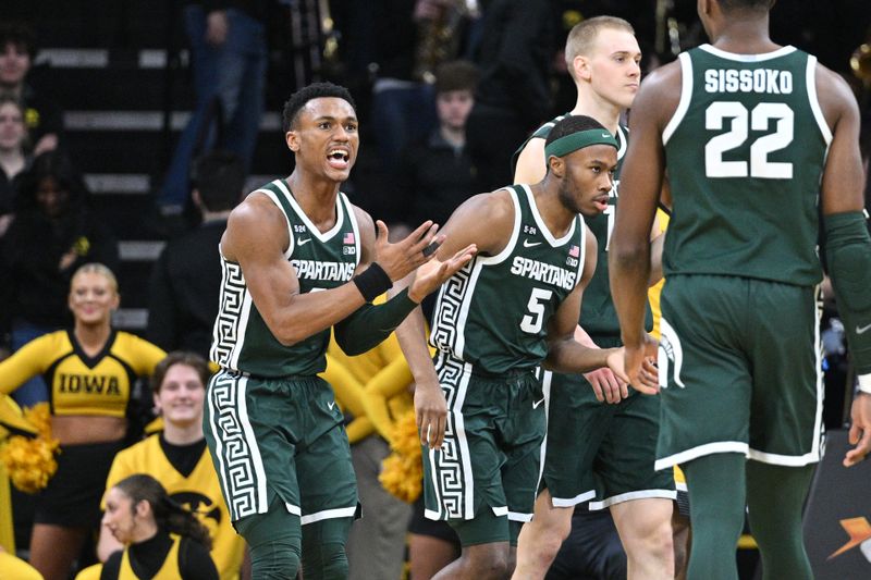 Feb 25, 2023; Iowa City, Iowa, USA; Michigan State Spartans guard Tyson Walker (2) reacts with center Mady Sissoko (22) as guard Tre Holloman (5) looks on during the first half against the Iowa Hawkeyes at Carver-Hawkeye Arena. Mandatory Credit: Jeffrey Becker-USA TODAY Sports