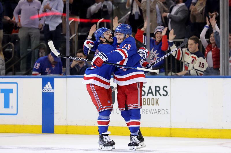 Mar 26, 2024; New York, New York, USA; New York Rangers defenseman Adam Fox (23) celebrates his game winning goal against the Philadelphia Flyers with center Vincent Trocheck (16) during overtime at Madison Square Garden. Mandatory Credit: Brad Penner-USA TODAY Sports