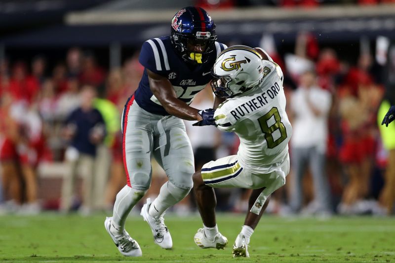 Sep 16, 2023; Oxford, Mississippi, USA; Georgia Tech Yellow Jackets wide receiver Malik Rutherford (8) catches a pass over Mississippi Rebels defensive back Trey Washington (25) during the first half at Vaught-Hemingway Stadium. Mandatory Credit: Petre Thomas-USA TODAY Sports