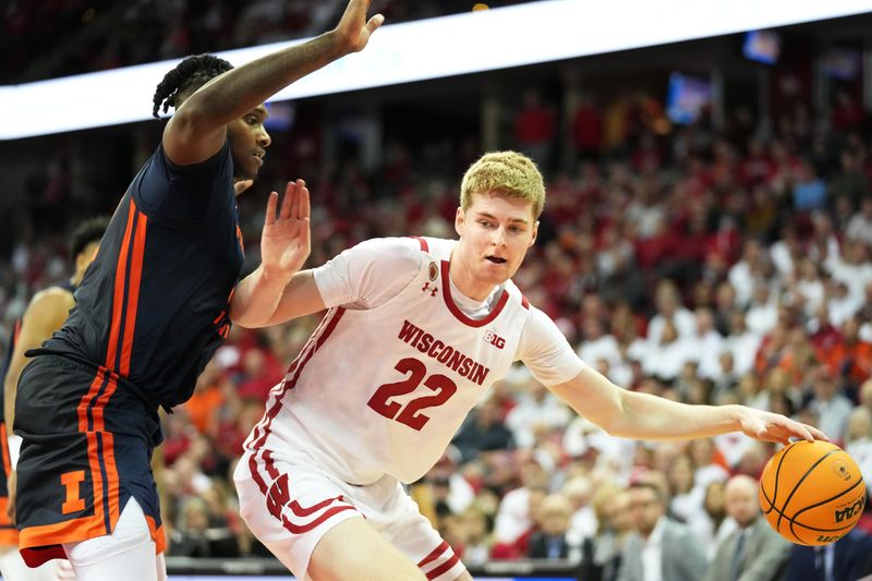 Jan 28, 2023; Madison, Wisconsin, USA;  Wisconsin Badgers forward Steven Crowl (22) dribbles the ball under coverage by Illinois Fighting Illini forward Dain Dainja (42) during the second half at the Kohl Center. Mandatory Credit: Kayla Wolf-USA TODAY Sports