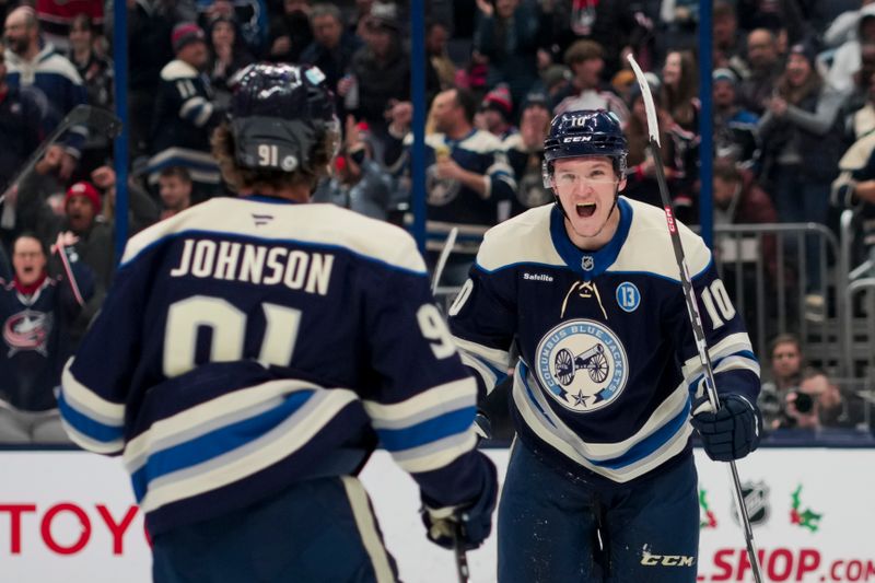 Nov 23, 2024; Columbus, Ohio, USA;  Columbus Blue Jackets left wing Dmitri Voronkov (10) celebrates with teammates after scoring a goal against the Carolina Hurricanes in the second period at Nationwide Arena. Mandatory Credit: Aaron Doster-Imagn Images