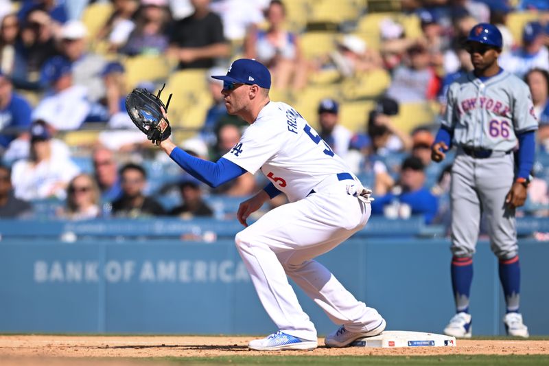 Apr 20, 2024; Los Angeles, California, USA; Los Angeles Dodgers first baseman Freddie Freeman (5) makes a catch at first base against the New York Mets during the ninth inning at Dodger Stadium. Mandatory Credit: Jonathan Hui-USA TODAY Sports