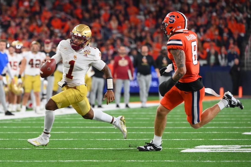 Nov 3, 2023; Syracuse, New York, USA; Boston College Eagles quarterback Thomas Castellanos (1) runs with the ball as Syracuse Orange defensive back Justin Barron (8) during the first half at the JMA Wireless Dome. Mandatory Credit: Rich Barnes-USA TODAY Sports