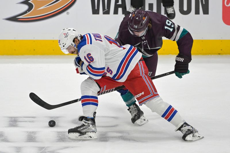 Jan 21, 2024; Anaheim, California, USA; New York Rangers center Vincent Trocheck (16) and Anaheim Ducks right wing Troy Terry (19) battle for the puck in the first period at Honda Center. Mandatory Credit: Jayne Kamin-Oncea-USA TODAY Sports