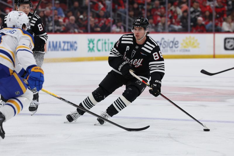 Dec 21, 2025; Newark, New Jersey, USA;  New Jersey Devils center Jack Hughes (86) looks to make a pass against the Buffalo Sabres during the first second at Prudential Center. Mandatory Credit: Thomas Salus-Imagn Images