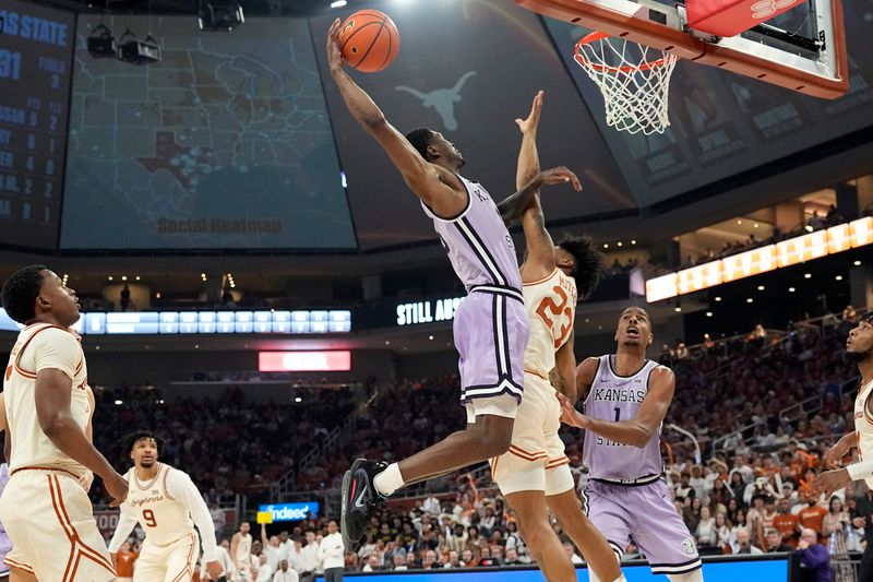 Feb 19, 2024; Austin, Texas, USA; Kansas State Wildcats guard Cam Carter (5) goes up to dunk over Texas Longhorns forward Dillon Mitchell (23) during the second half at Moody Center. Mandatory Credit: Scott Wachter-USA TODAY Sports