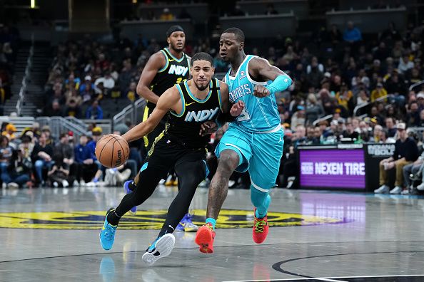 INDIANAPOLIS, INDIANA - DECEMBER 20: Tyrese Haliburton #0 of the Indiana Pacers dribbles the ball while being guarded by Terry Rozier #3 of the Charlotte Hornets in the first quarter at Gainbridge Fieldhouse on December 20, 2023 in Indianapolis, Indiana. NOTE TO USER: User expressly acknowledges and agrees that, by downloading and or using this photograph, User is consenting to the terms and conditions of the Getty Images License Agreement. (Photo by Dylan Buell/Getty Images)